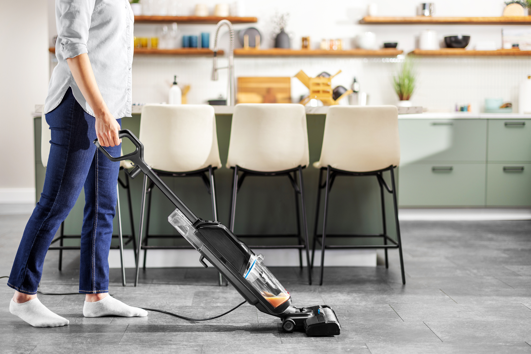 Vacuuming the kitchen floor