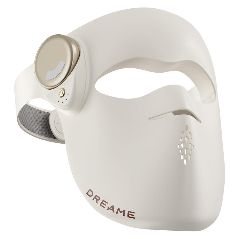 A white and beige facial mask device with a head strap, featuring the brand name DREAME printed in brown on the lower front, set against a plain white background.