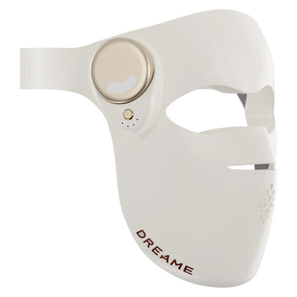 A white LED neck and face mask with a gold-toned circular control dial and the brand name 'DREAME' printed in dark red near the bottom, shown on a solid white background.
