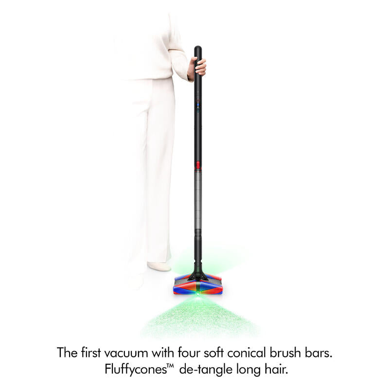 A person in white clothing holds a cordless stick vacuum cleaner with four soft conical brush bars at the base, shown against a white background with green and red light effects and product text below.