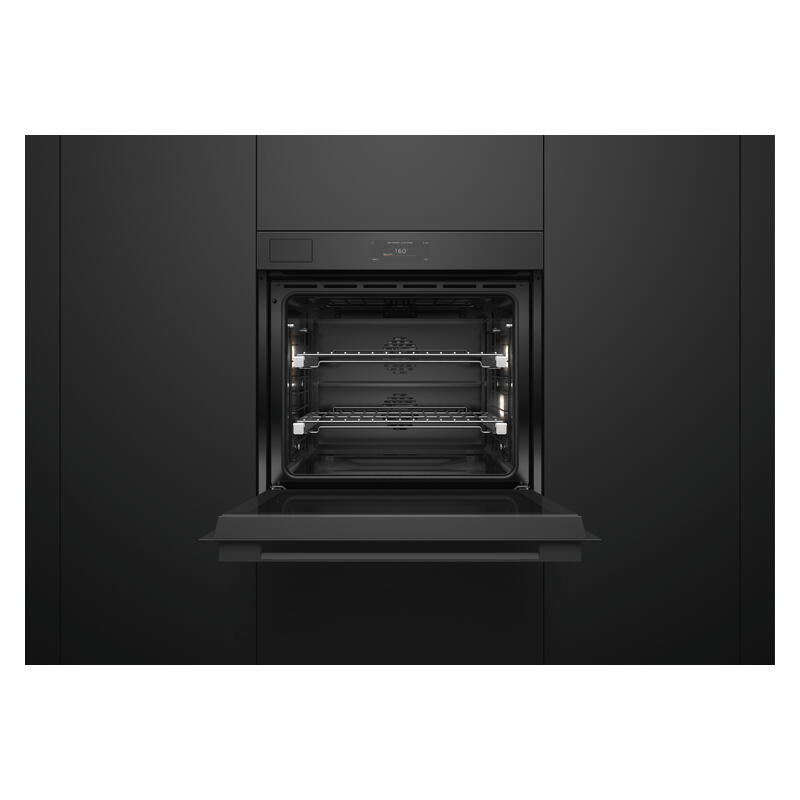 A built-in black wall oven with its door open, showing the interior racks and light elements, set against a matching black kitchen cabinet background.