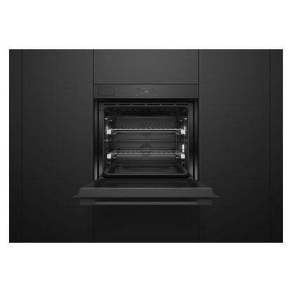 A built-in black wall oven with its door open, showing the interior racks and light elements, set against a matching black kitchen cabinet background.