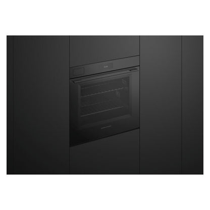 A built-in black oven or wall oven shown in a modern dark kitchen setting, with a glass door and control panel above it.