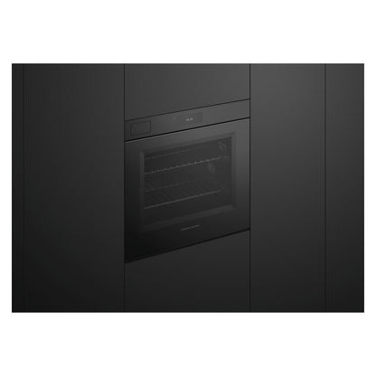 A built-in black oven or wall oven with a glass door, shown installed between dark kitchen cabinets.