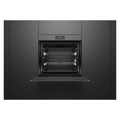 A built-in wall oven with its door open, showing the interior racks and light elements, set within dark charcoal kitchen cabinets.