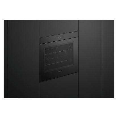 A built-in black oven or wall oven with a glass door, shown installed between dark kitchen cabinets.