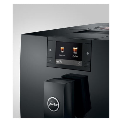 A close-up of a black Jura coffee machine showing its digital touch screen with espresso and coffee options, and the Jura logo on the dispensing tower, set against a neutral gray background.