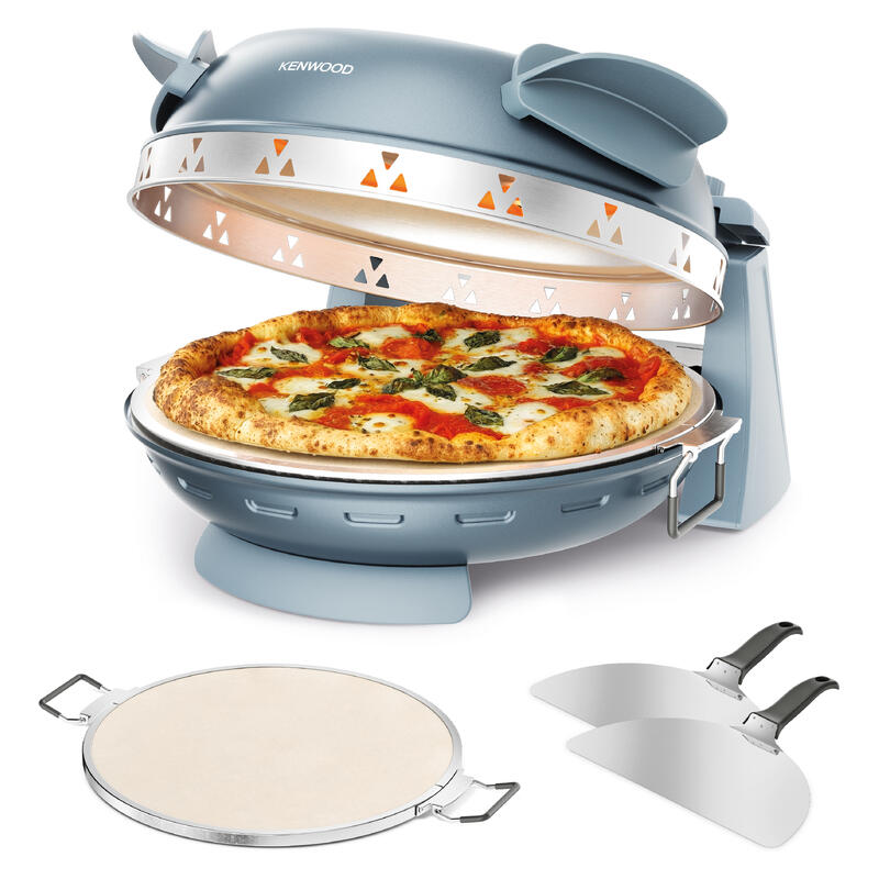 Kenwood countertop pizza oven in a muted blue-gray color, shown with its lid open and a pizza inside. Two metal pizza peelers and a round stone are displayed in front on a clean white background.