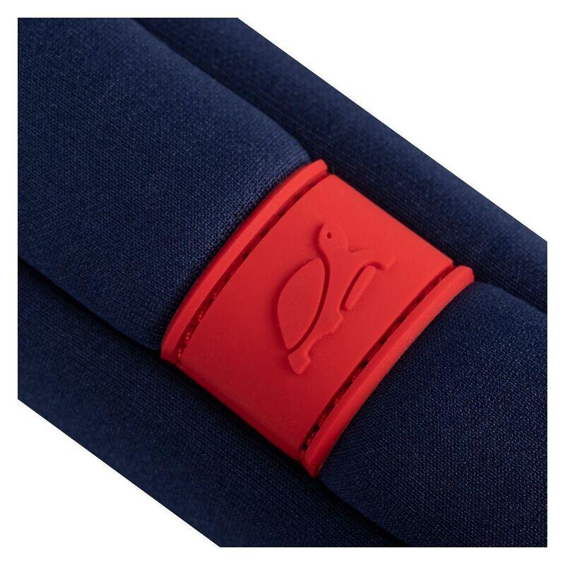 Close-up of a navy blue fabric item with a bright red silicone band featuring an embossed penguin logo, on a white background.