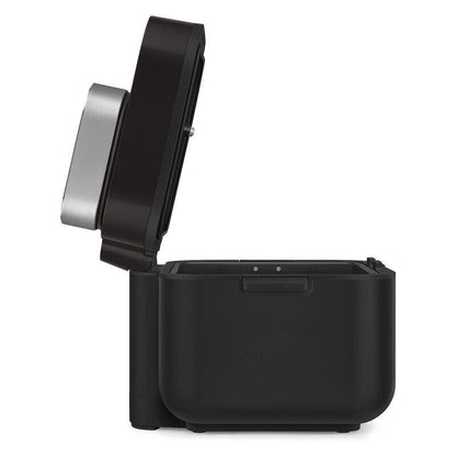 A black countertop Air Fryer with its lid open, showing a silver inner chamber, on a solid white background.