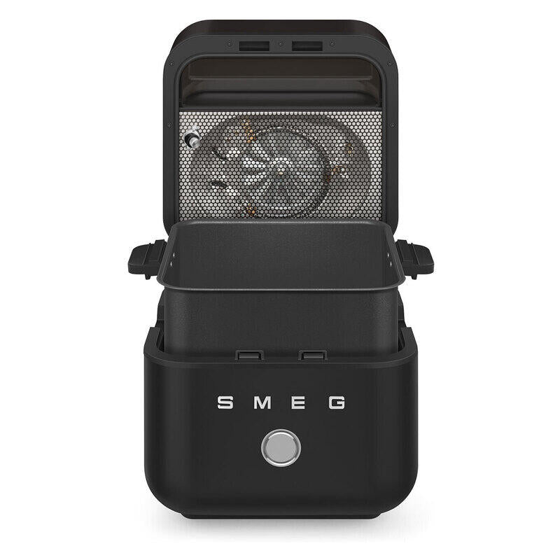 A black SMEG countertop electric Air Fryer with its lid open, showing the interior heating element, on a solid white background.
