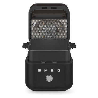 A black SMEG countertop electric Air Fryer with its lid open, showing the interior heating element, on a solid white background.