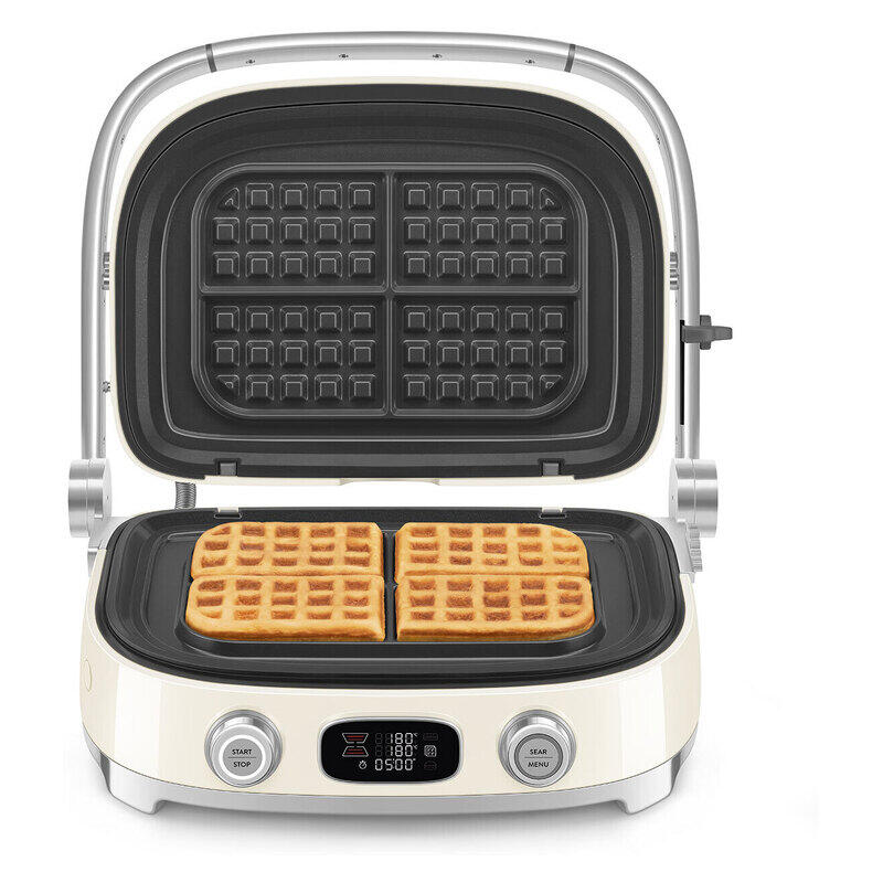 A cream-colored electric waffle maker with its lid open, showing two golden-brown waffles cooking on the black non-stick plates. The appliance features a digital display screen and two silver control knobs on the front panel, set against a plain white background.