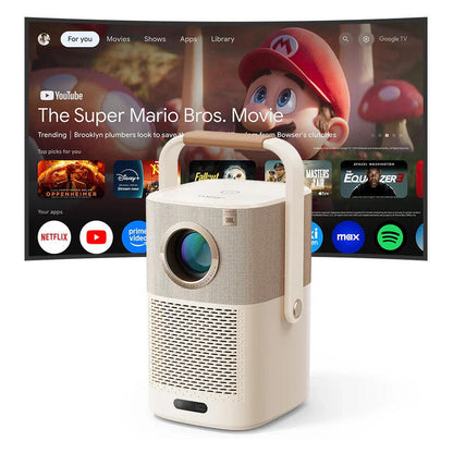 A portable projector in the foreground with a beige body and light wood handle, shown in front of a large TV screen displaying Netflix and Google TV content.