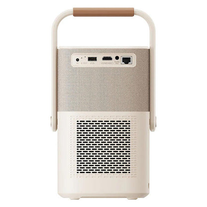 A portable speaker with a cream-colored body, a beige textured mesh grille, and a brown leatherette handle, shown against a plain white background. Image shows all ports that can be used including a HDMI port and USB port.
