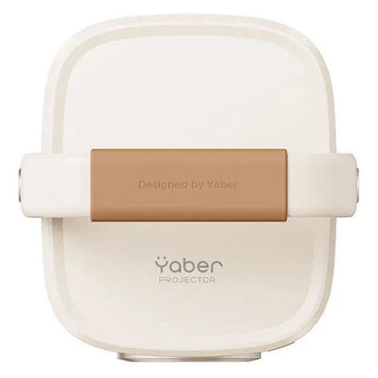 A Yaber Projector compact device in a warm off-white color with a tan accent band across the middle, featuring the Yaber logo and 'Designed by Yaber' text.